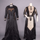 TWO TRAINED BLACK DRESSES, EARLY 20TH C